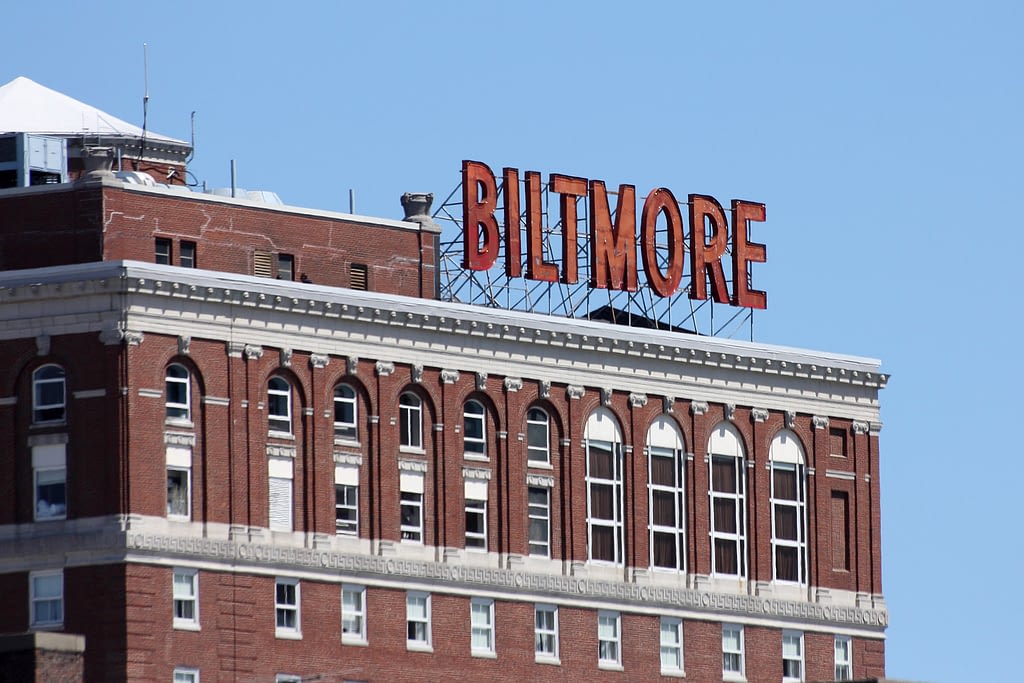 Close-up of red Biltmore sign on top of brick building
