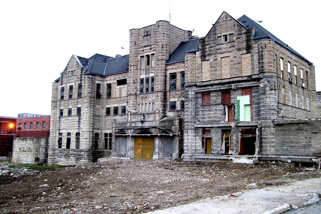 Old abandoned tan building, falling apart