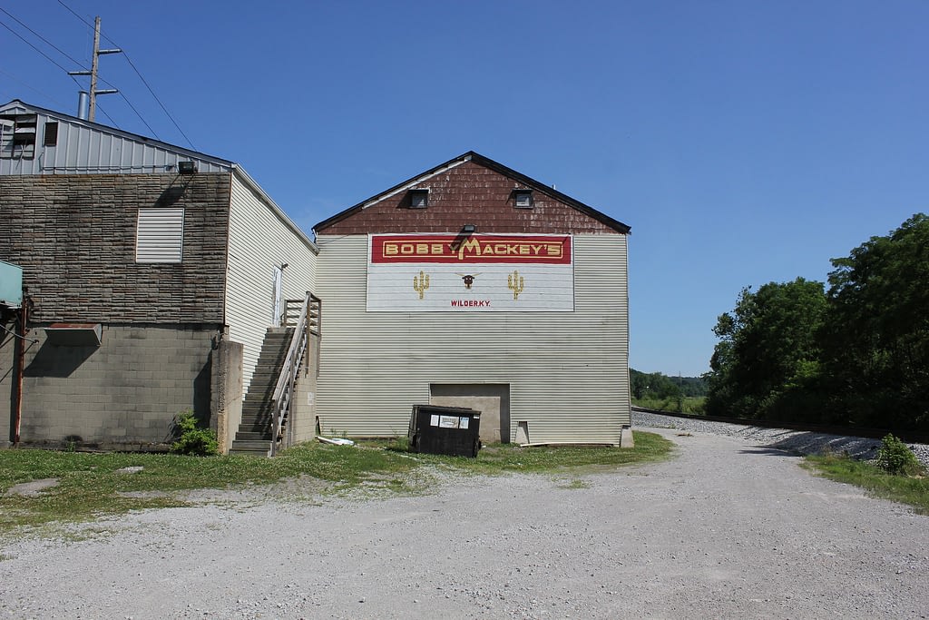 Box building with red, white, and yellow Bobby Mackey's sign