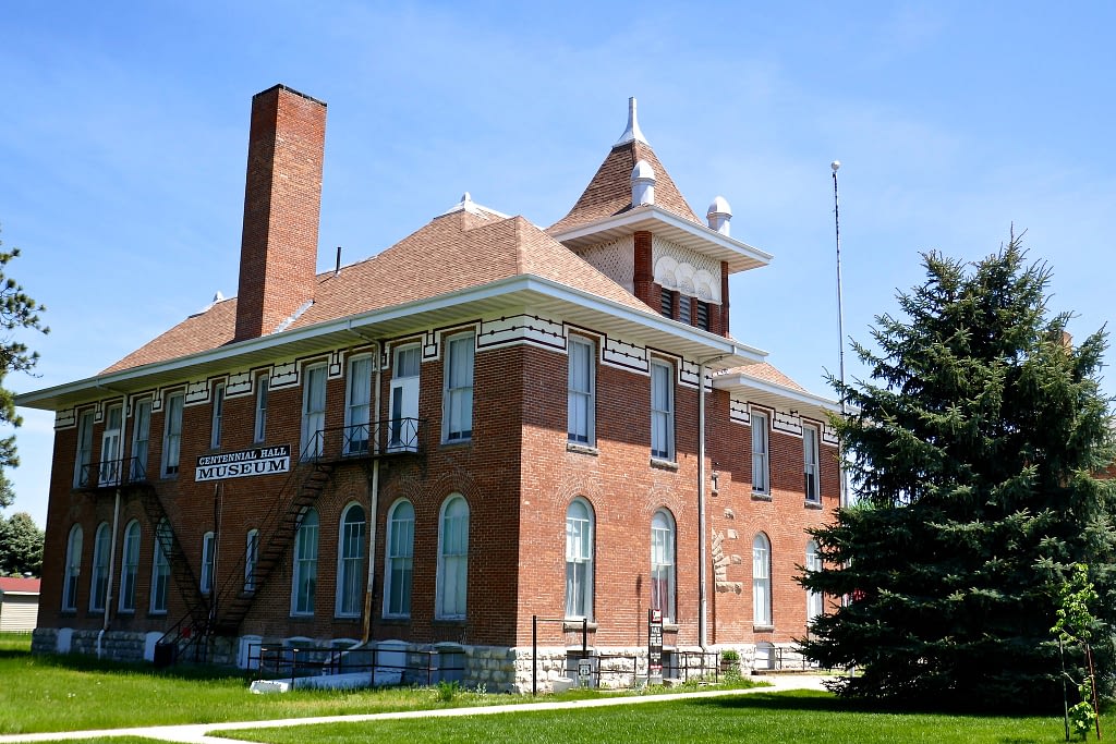 Brick building with black and white Centennial Hall Museum sign