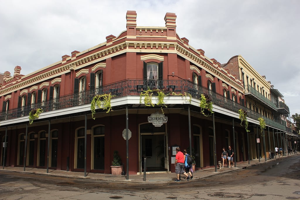 Corner building, red bricks with balcony going around the top
