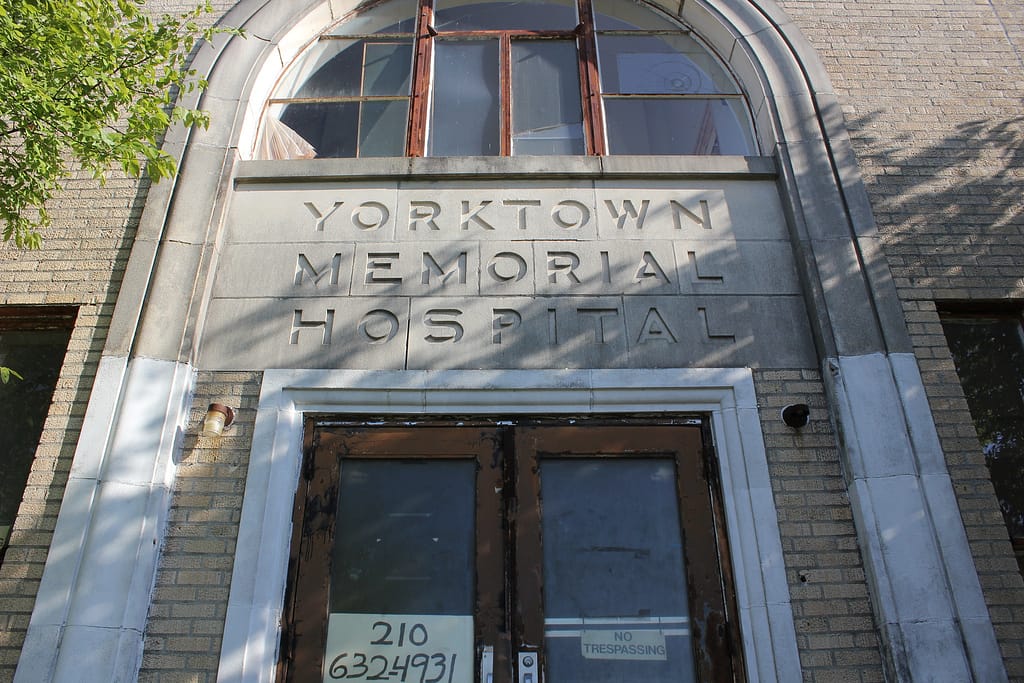 Entrance of tan building which reads Yorktown Memorial Hospital