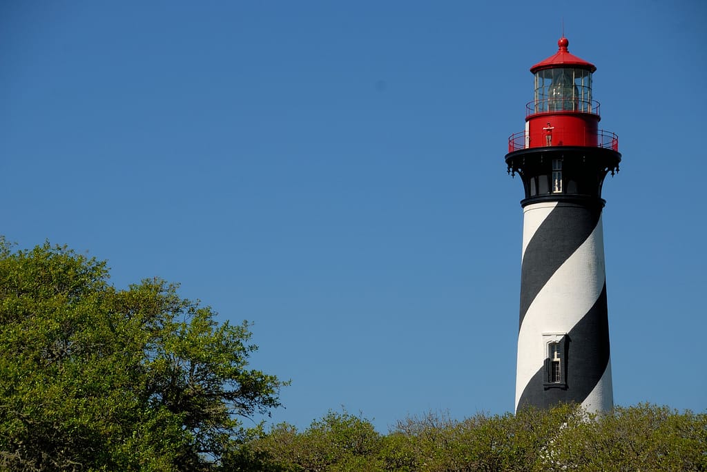 Lighthouse with red top and black/white stripes along the sides