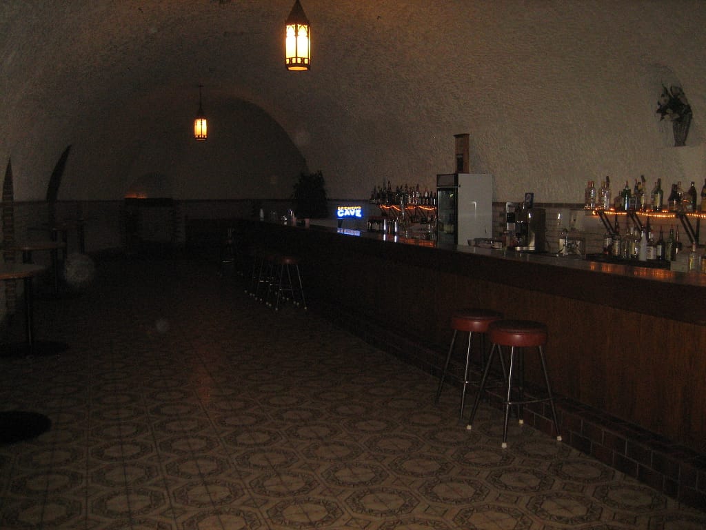 Dark bar inside a cave, patterned tile flooring