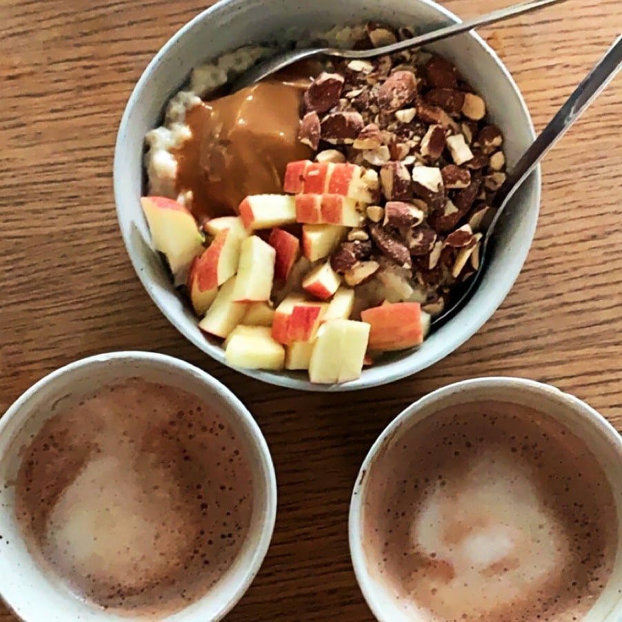 Oatmeal with apples, caramel sauce, and nuts. Hot chocolate.